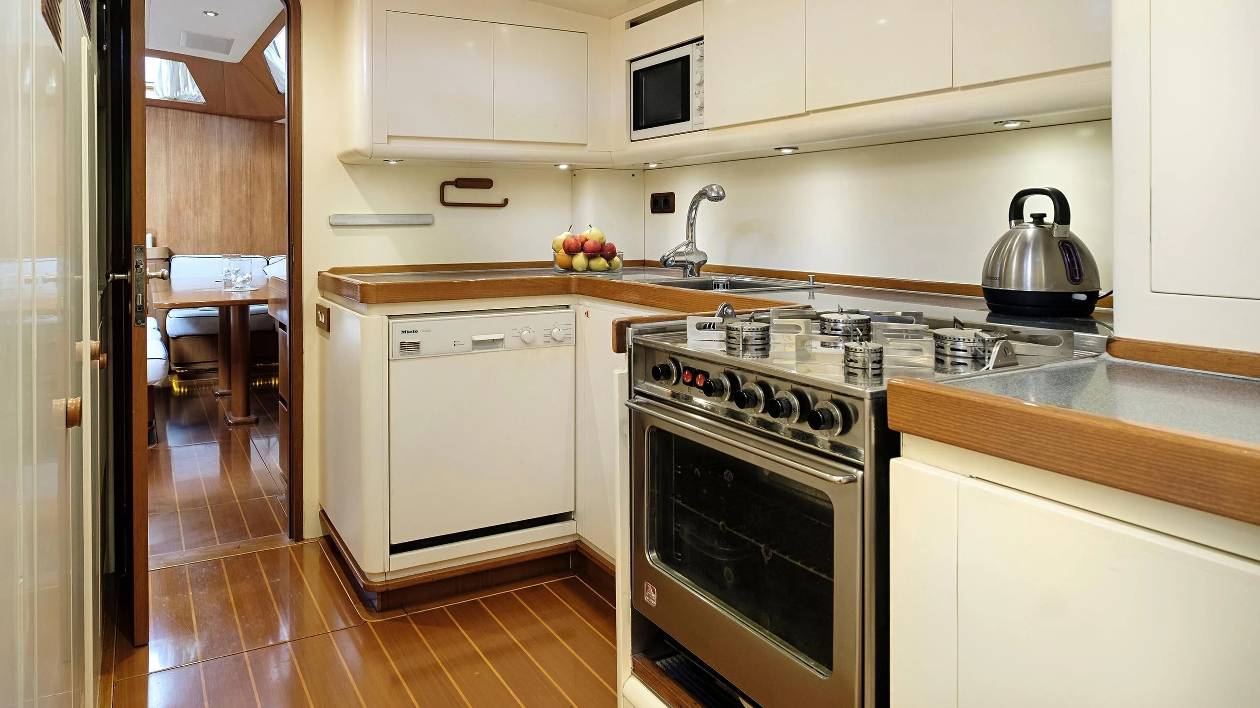 a kitchen with white cabinets aboard NINA I Yacht for Sale