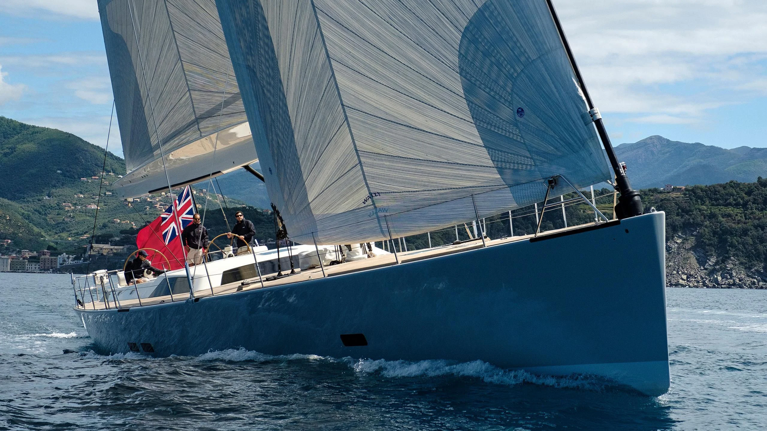 a boat with a flag on it aboard NINA I Yacht for Sale
