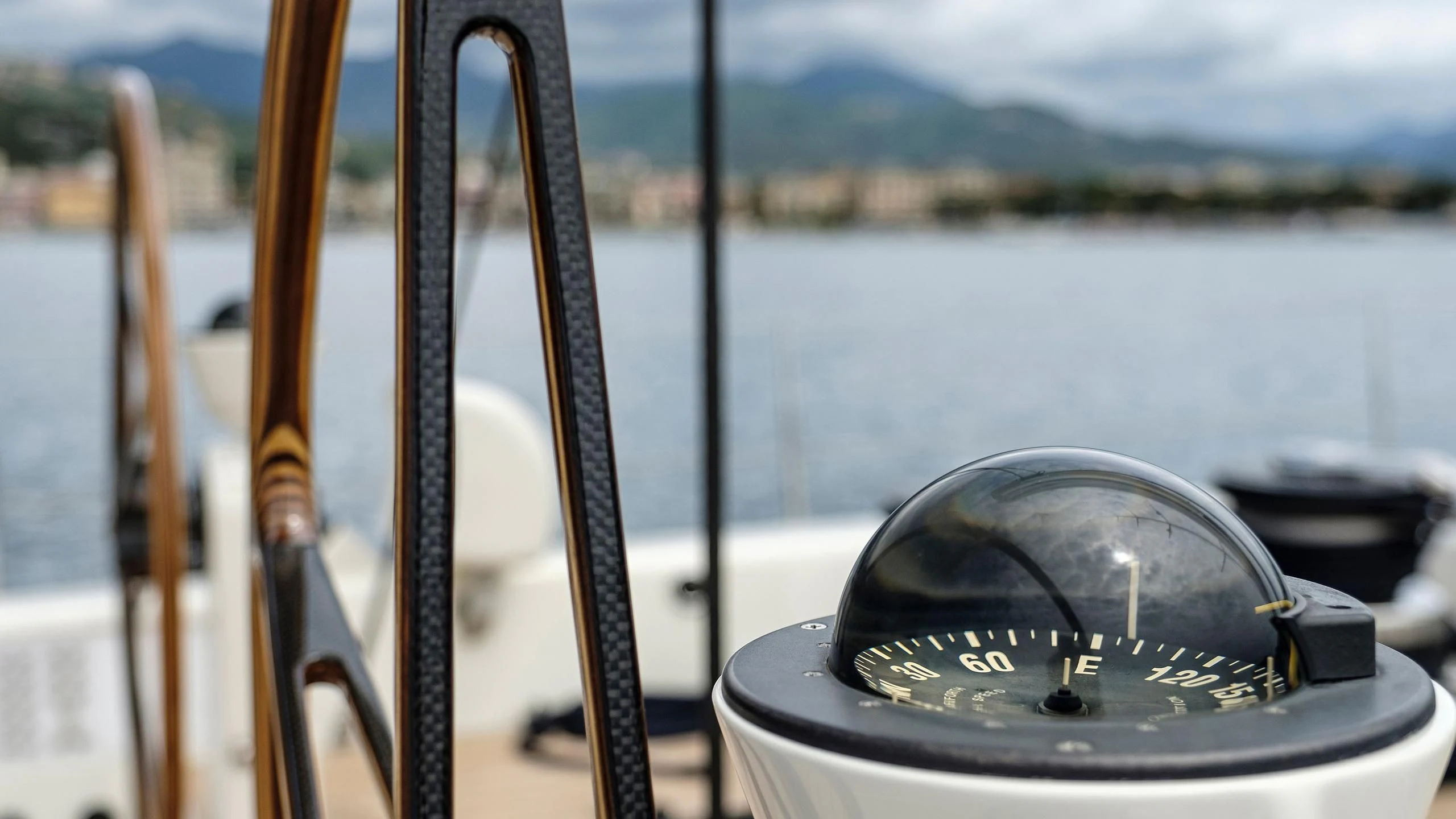 a steering wheel and dashboard of a boat on a body of water aboard NINA I Yacht for Sale