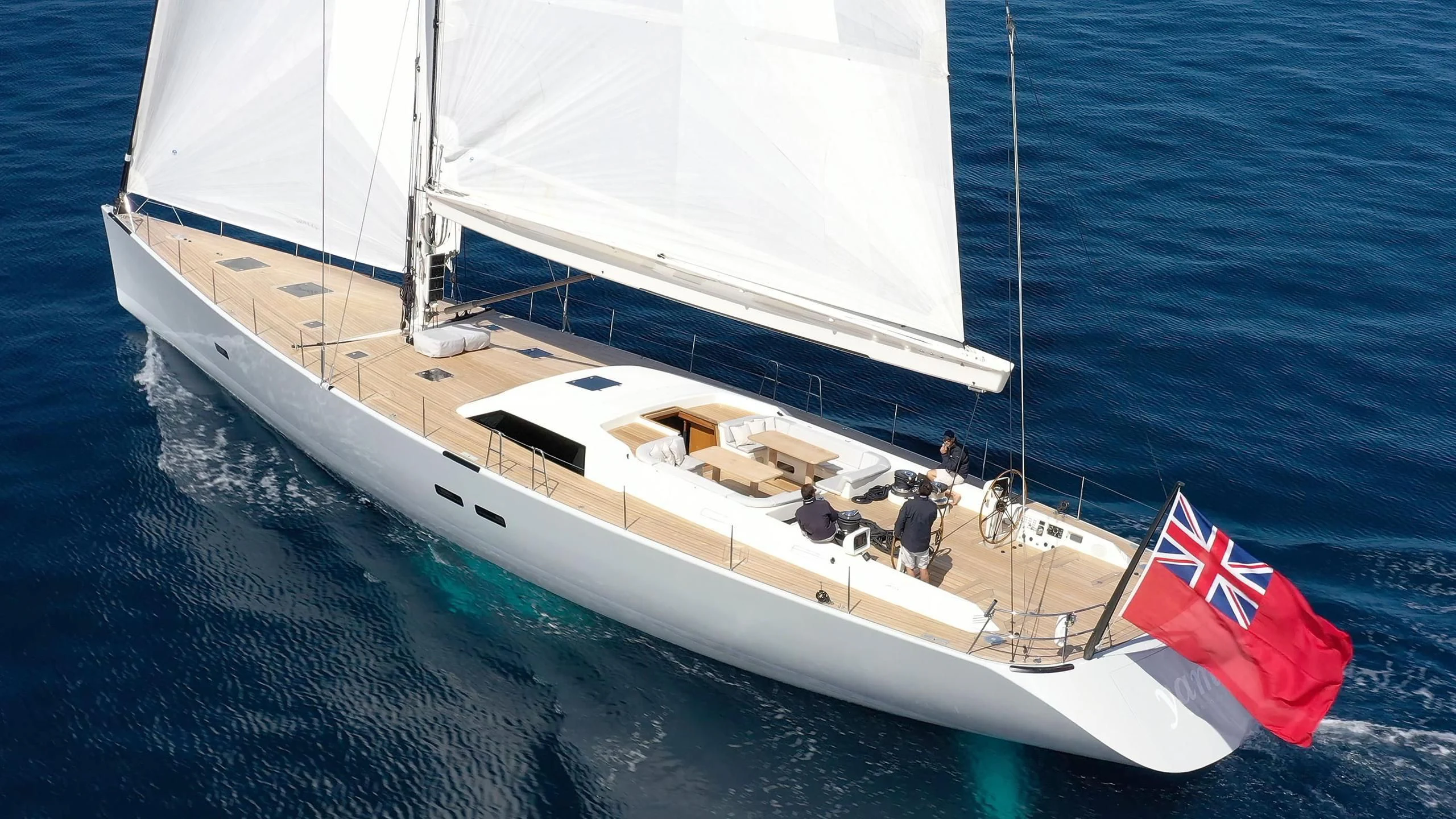 a boat with a flag on the front aboard NINA I Yacht for Sale