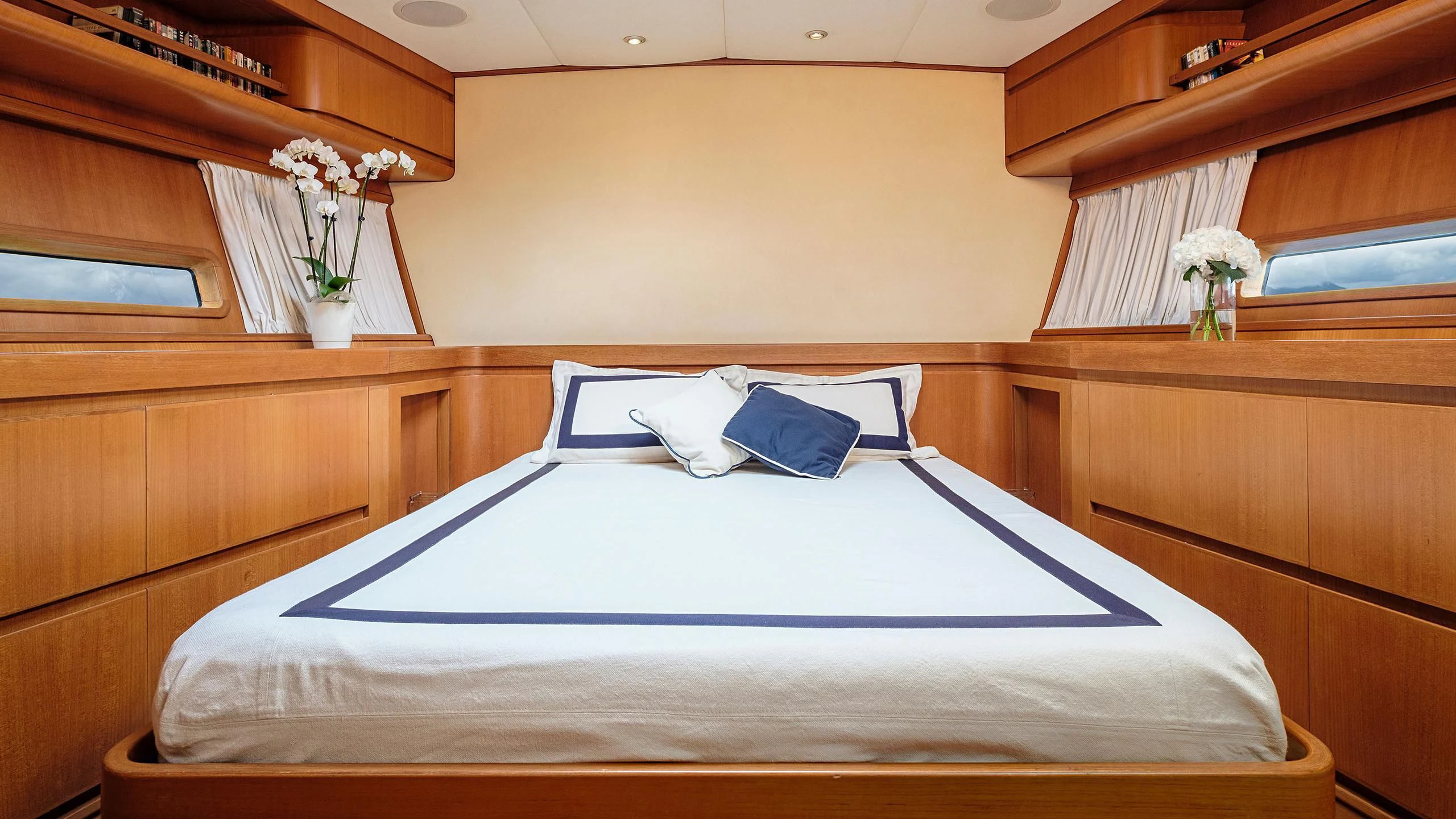 a bed with white sheets and pillows aboard NINA I Yacht for Sale