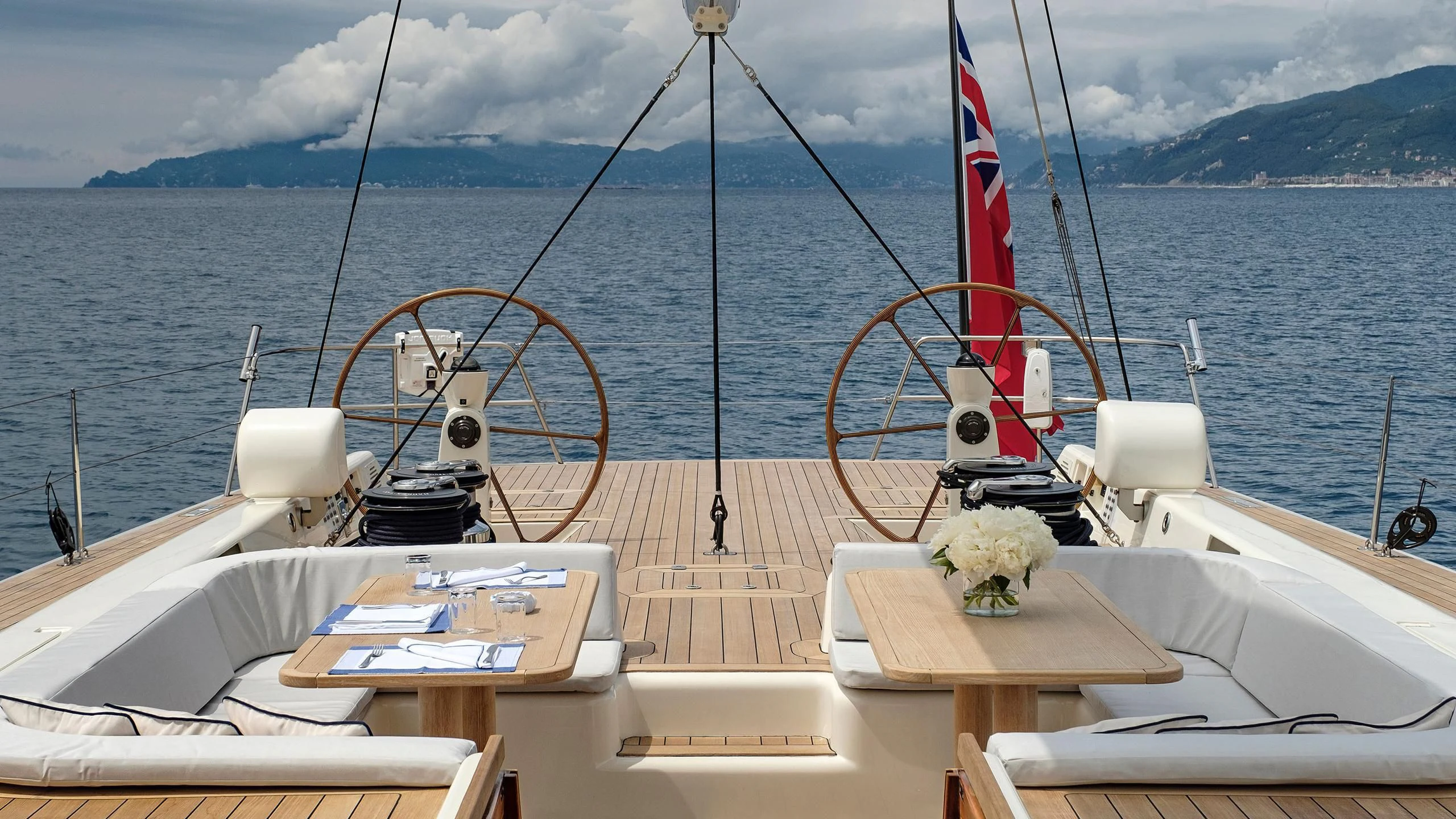 a boat with a red flag on the front aboard NINA I Yacht for Sale