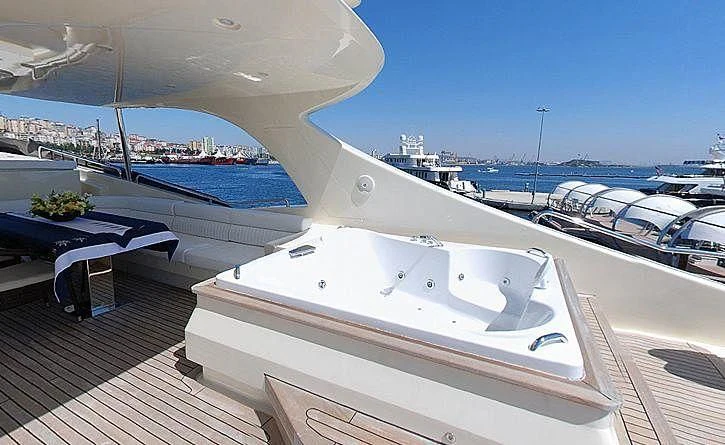 a deck with a view of a marina and boats aboard COSMOS LUNA Yacht for Sale