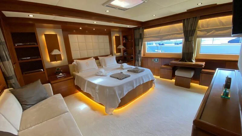 a hotel room with a bed and a table aboard COSMOS LUNA Yacht for Sale