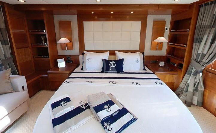 a large bed with white sheets aboard COSMOS LUNA Yacht for Sale