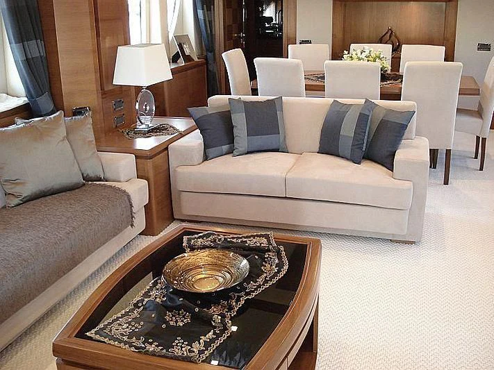 a living room with a couch and a coffee table aboard COSMOS LUNA Yacht for Sale