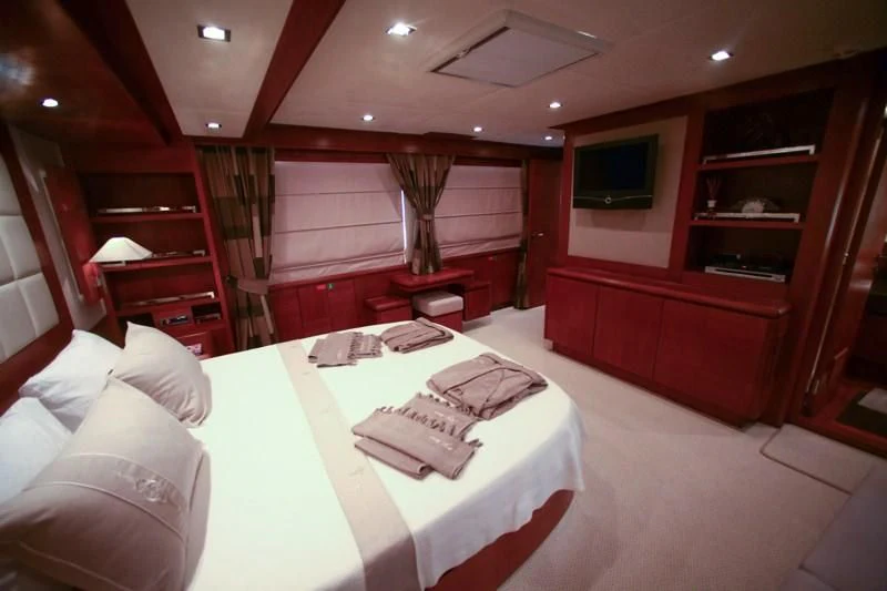 a room with a bed and a television aboard COSMOS LUNA Yacht for Sale