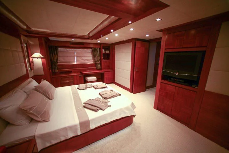 a hotel room with a bed and tv aboard COSMOS LUNA Yacht for Sale