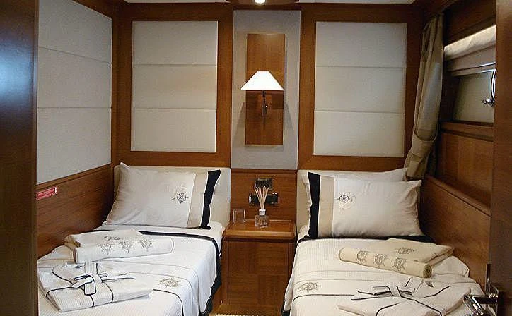 a room with a bed and a lamp aboard COSMOS LUNA Yacht for Sale