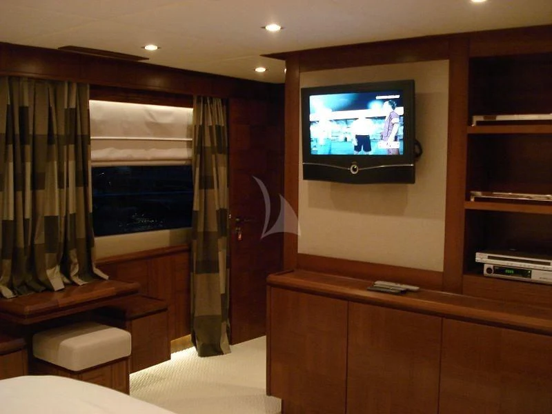 a tv on a stand in a room with a window aboard COSMOS LUNA Yacht for Sale