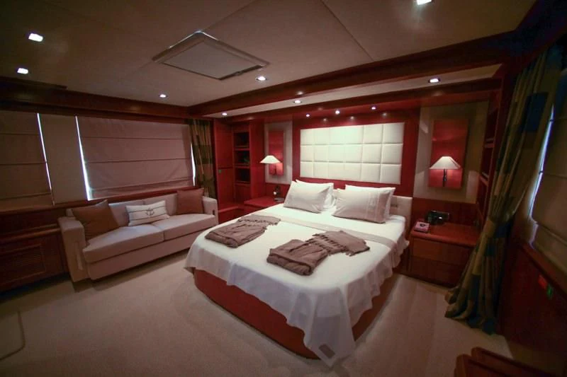 a room with a bed and a couch aboard COSMOS LUNA Yacht for Sale