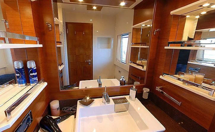 a bathroom with a countertop sink and cabinets aboard COSMOS LUNA Yacht for Sale