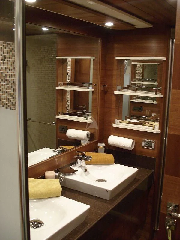 a bathroom with a sink and a mirror aboard COSMOS LUNA Yacht for Sale