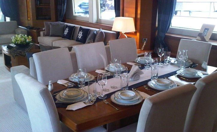 a table set with plates and glasses aboard COSMOS LUNA Yacht for Sale