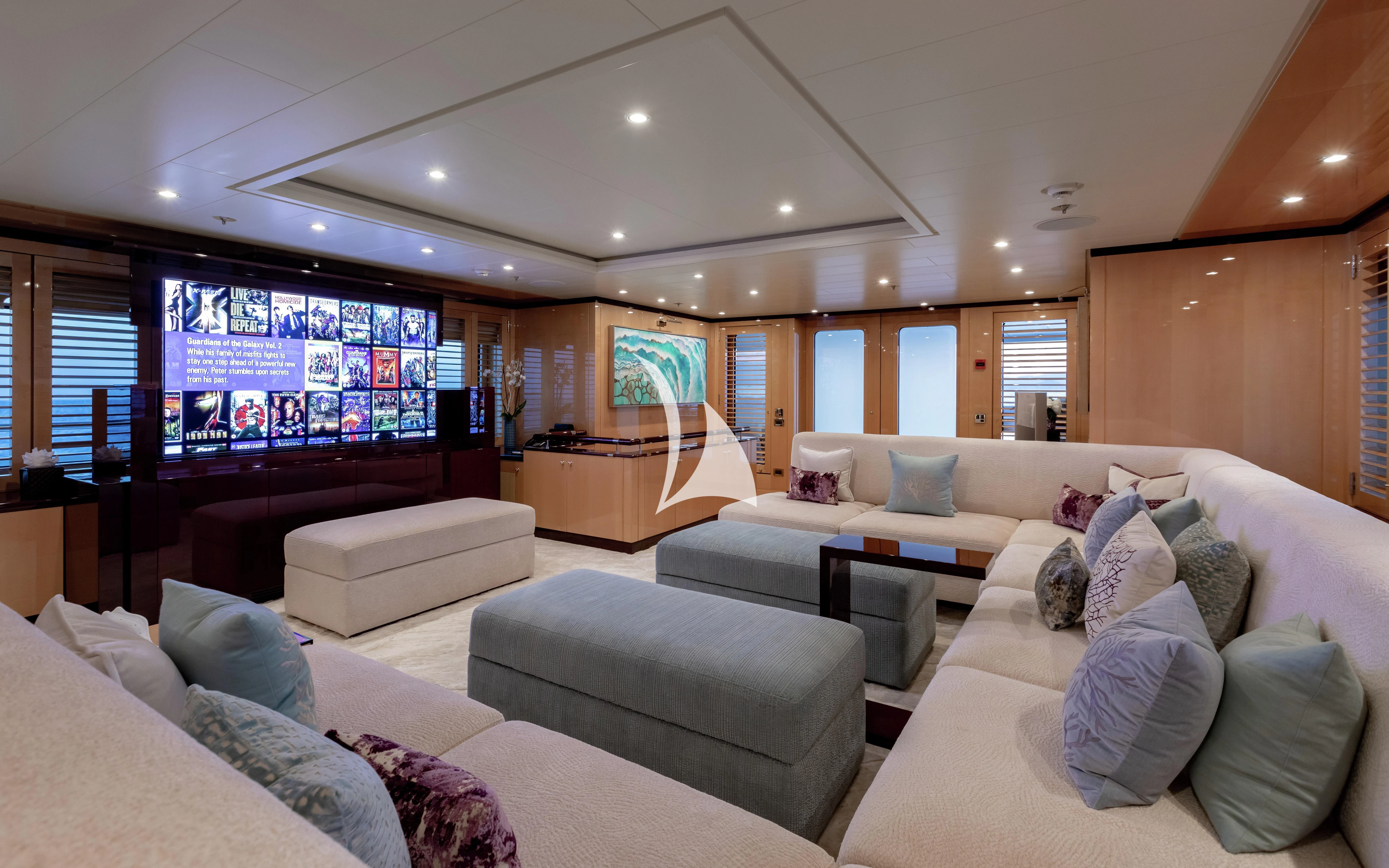 a living room with a large screen aboard LA MIRAGE Yacht for Sale