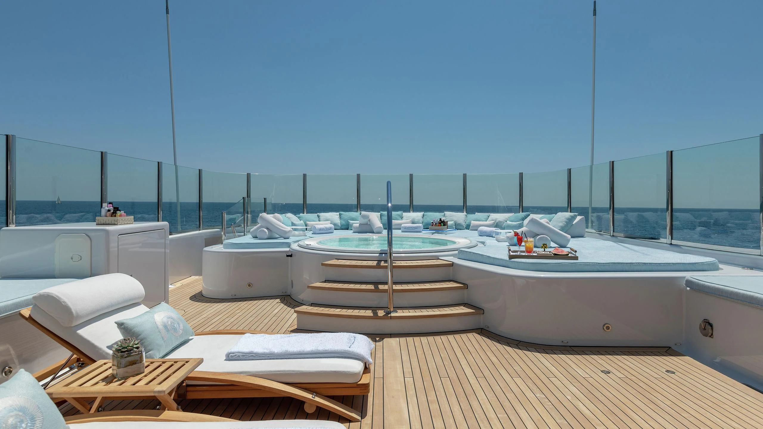 a room with a large deck overlooking the ocean aboard LA MIRAGE Yacht for Sale