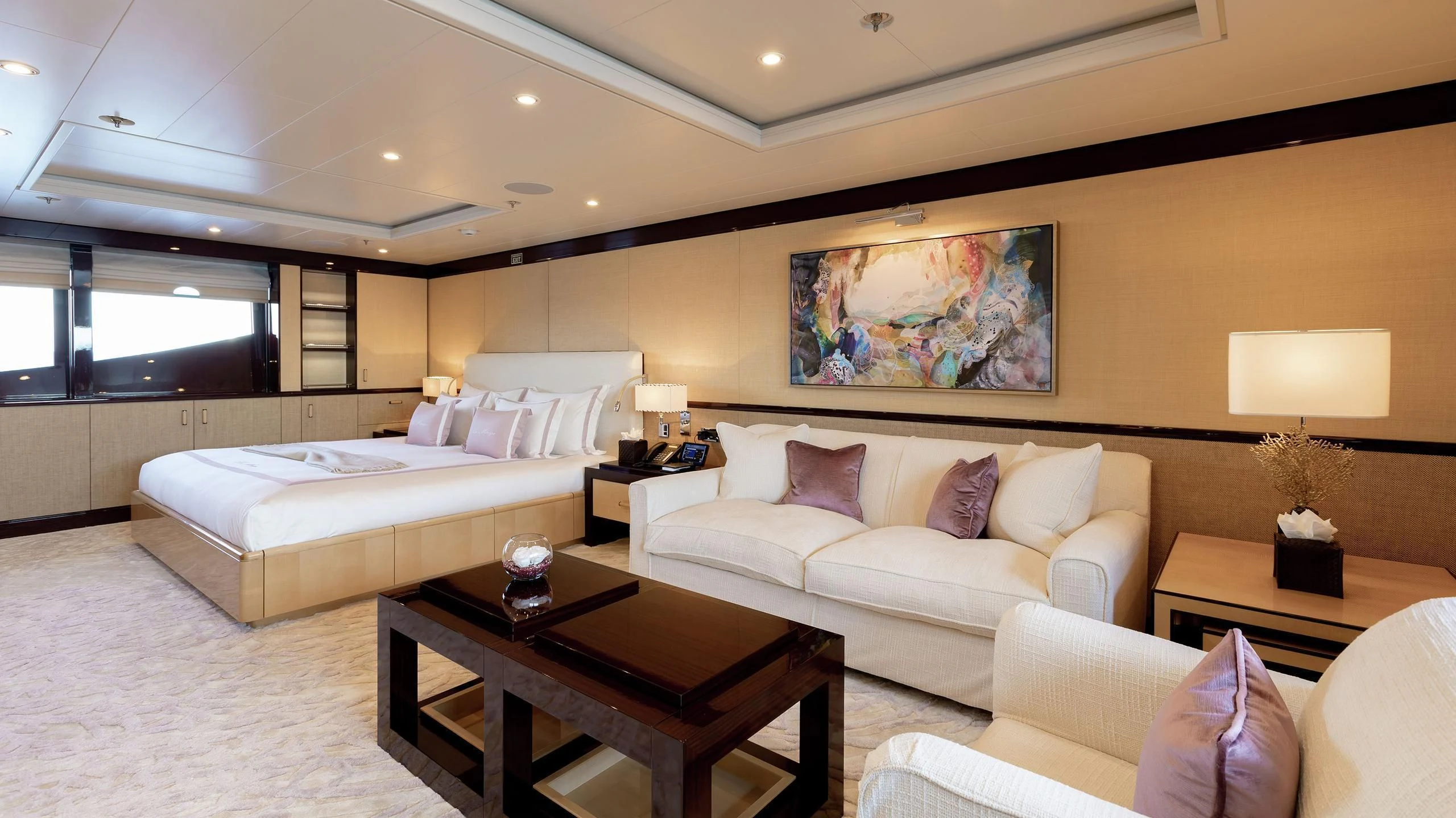 a living room with a couch and a coffee table aboard LA MIRAGE Yacht for Sale