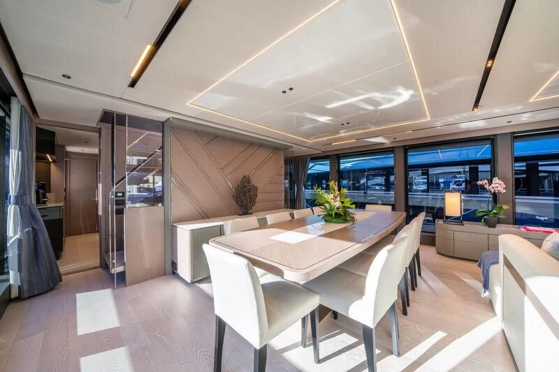 a room with a table and chairs aboard IKAL Yacht for Sale