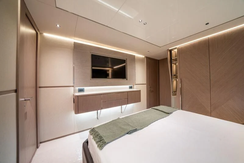 a bedroom with a bed and a television aboard IKAL Yacht for Sale