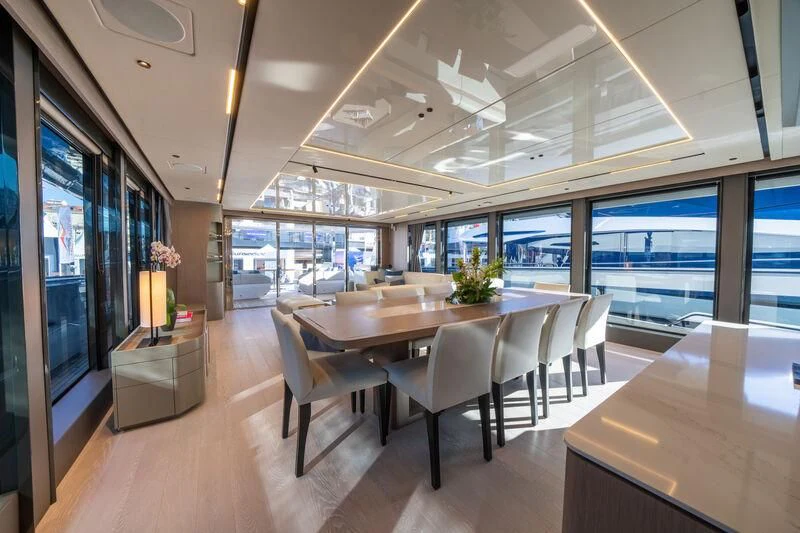 a large room with a table and chairs aboard IKAL Yacht for Sale