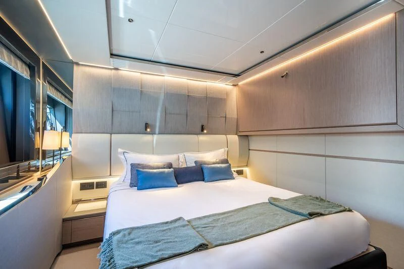 a room with a bed and a window aboard IKAL Yacht for Sale
