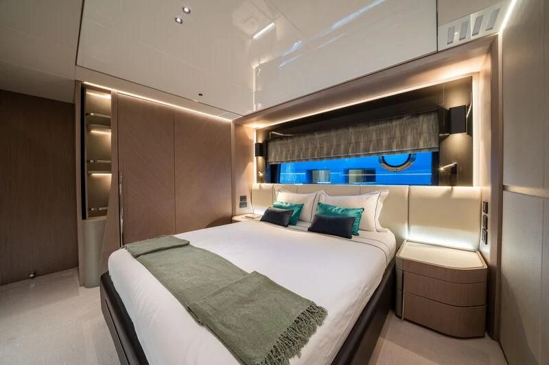 a room with a bed and a desk aboard IKAL Yacht for Sale