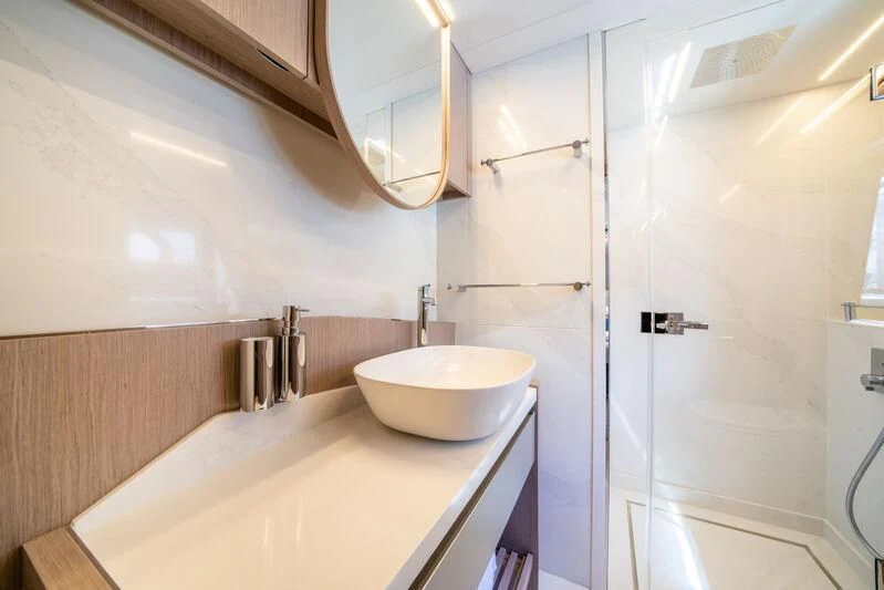 a bathroom with a sink and a mirror aboard IKAL Yacht for Sale