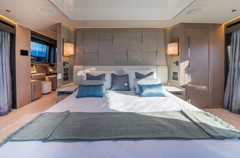 a large bed in a hotel room aboard IKAL Yacht for Sale