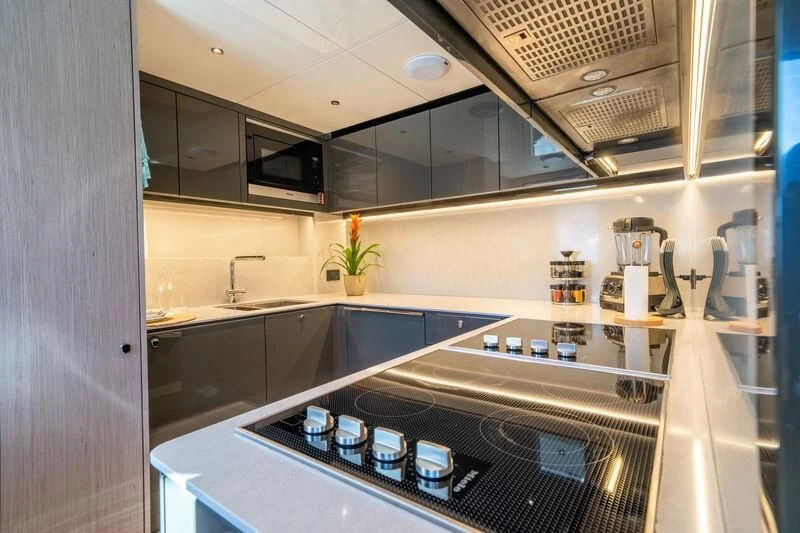 a kitchen with a stove and a sink aboard IKAL Yacht for Sale