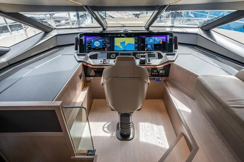 a table with a chair and a couch in a car aboard IKAL Yacht for Sale