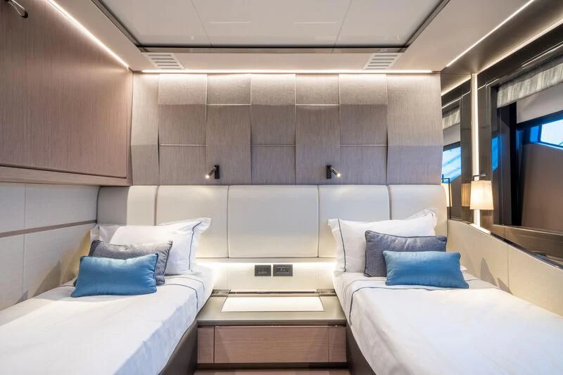a room with beds and a tv aboard IKAL Yacht for Sale