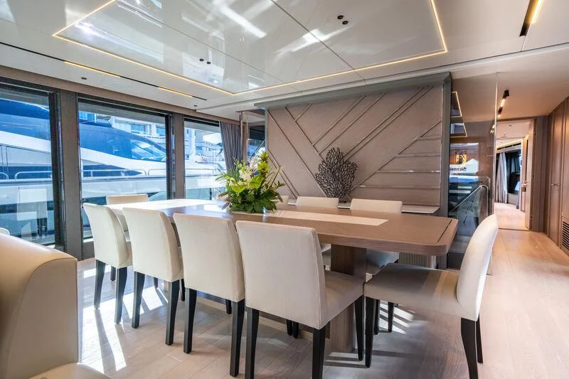 a room with a table and chairs aboard IKAL Yacht for Sale