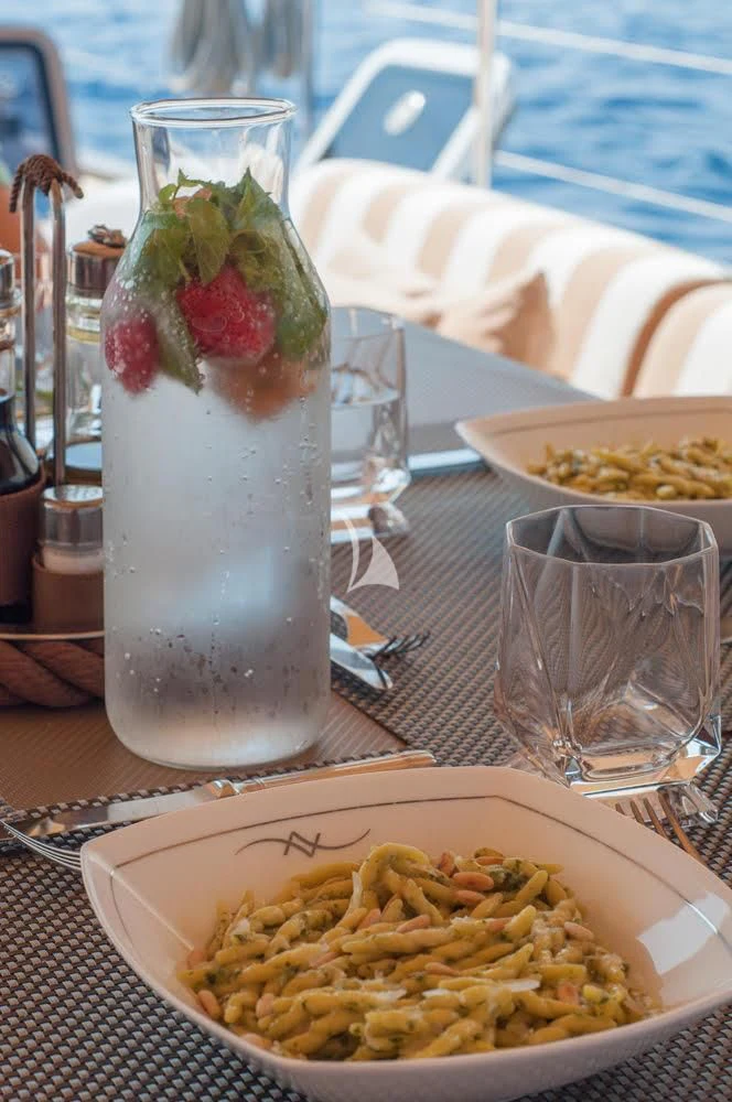 a glass of milk next to a bowl of pasta and a strawberries aboard FAR AND WIDE Yacht for Sale