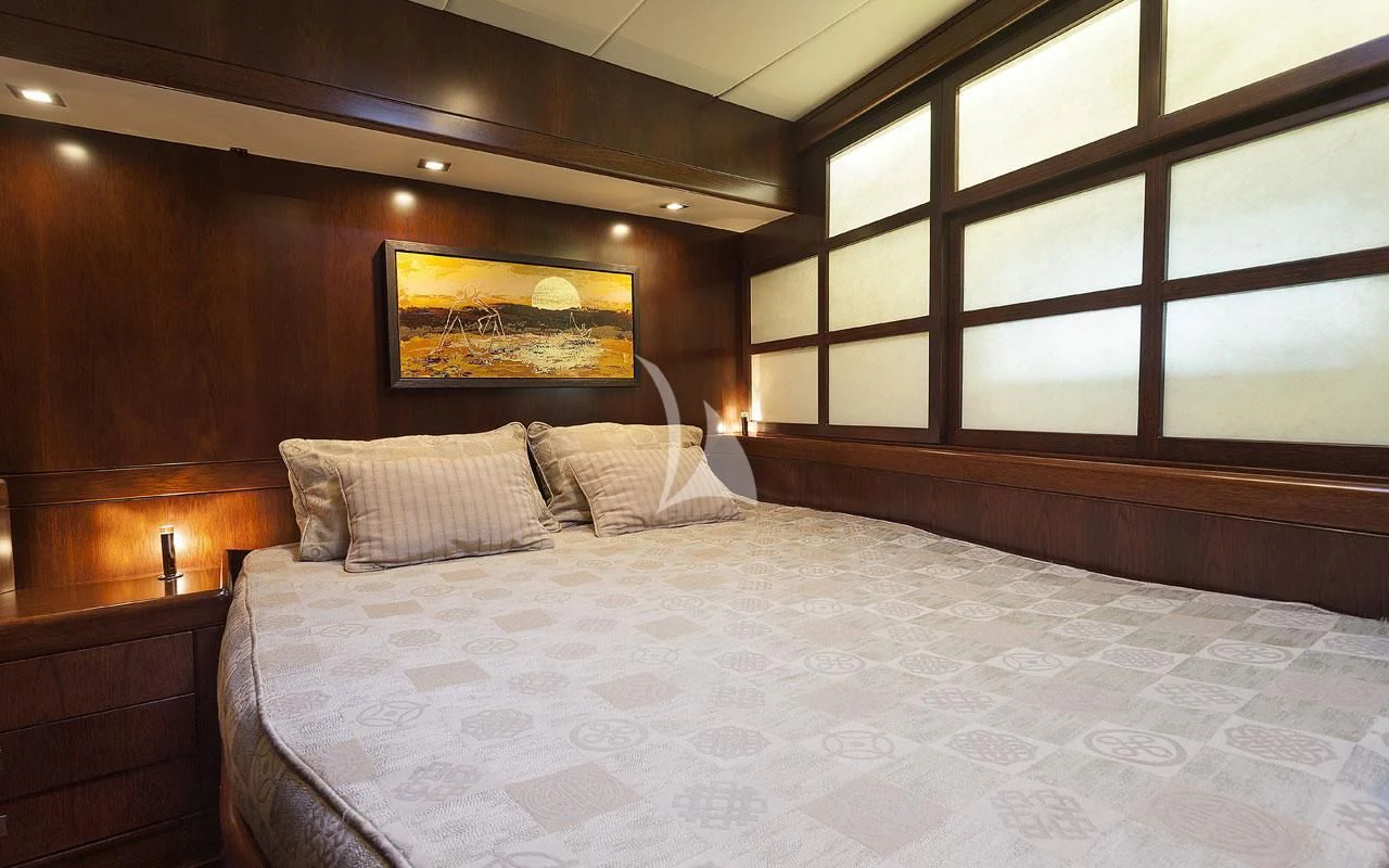 a bed with a white comforter aboard FAR AND WIDE Yacht for Sale