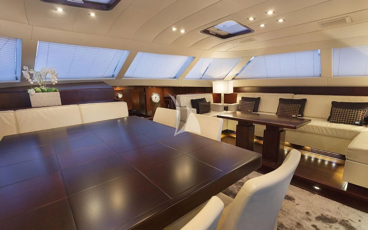 a room with a large table and chairs aboard FAR AND WIDE Yacht for Sale