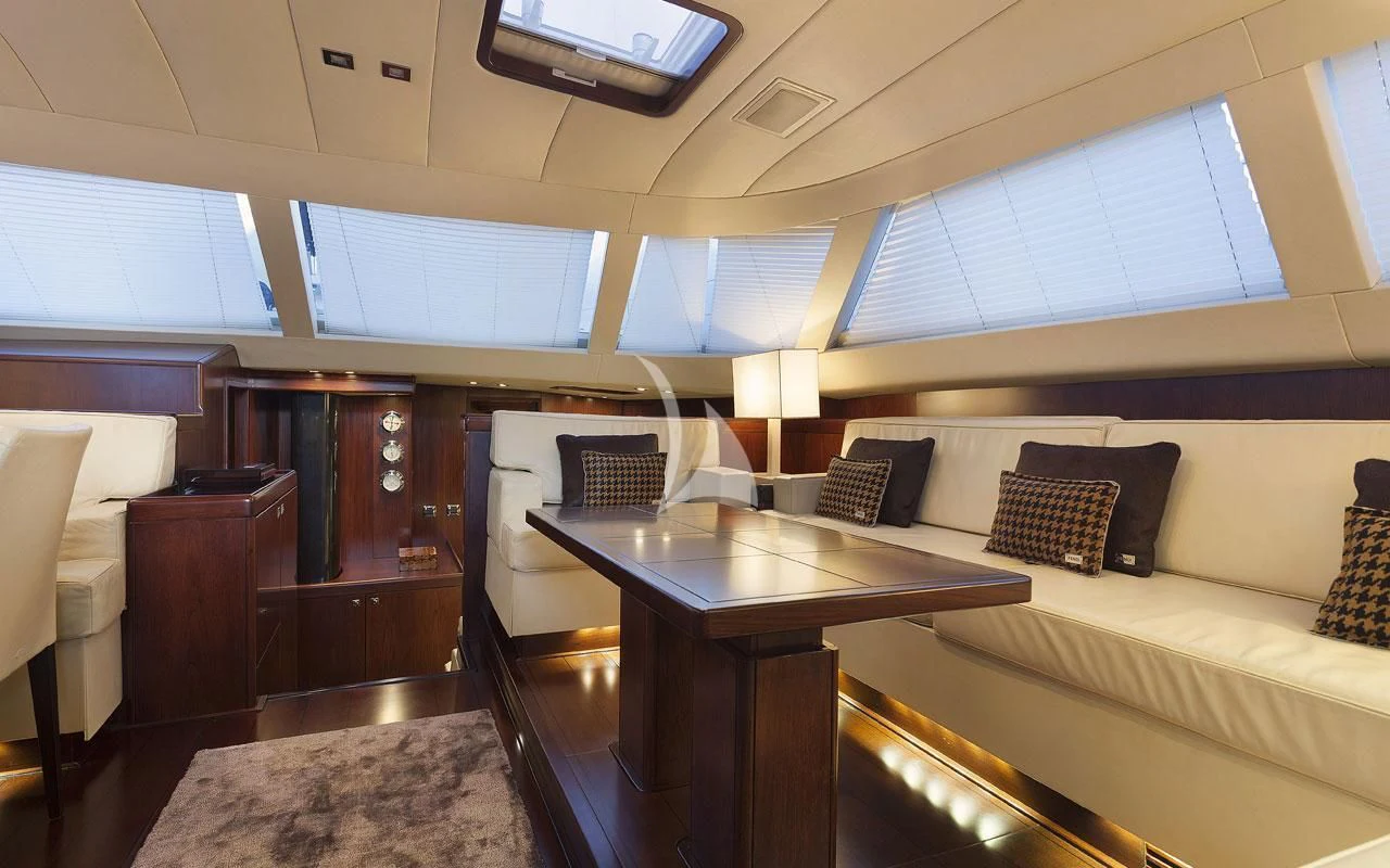 a room with a table and couch aboard FAR AND WIDE Yacht for Sale