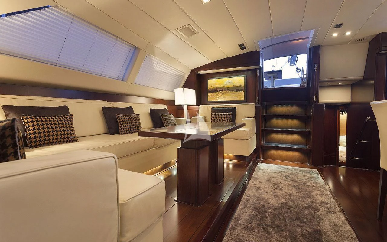 a living room with a couch and a coffee table aboard FAR AND WIDE Yacht for Sale