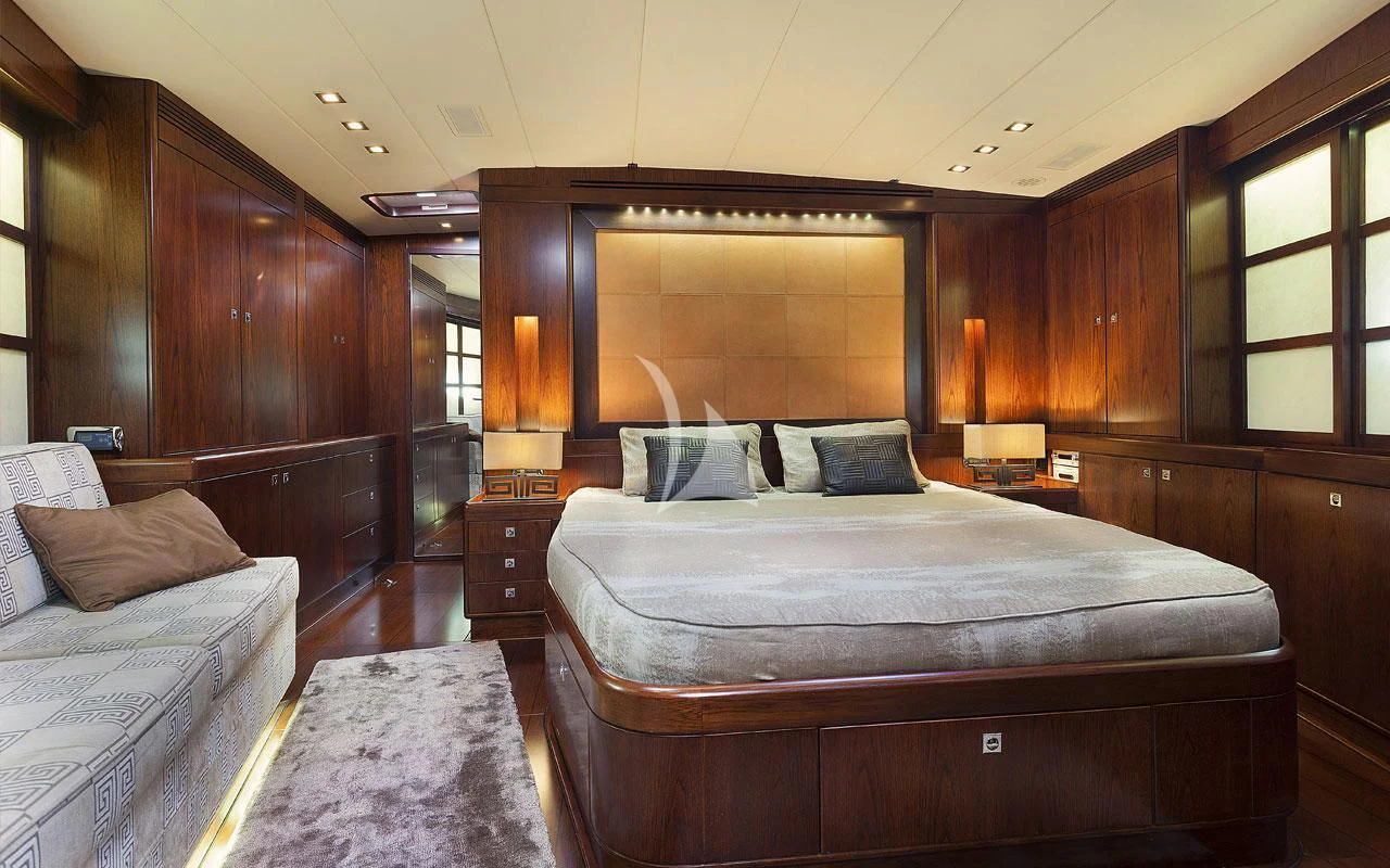 a room with a bed and a couch aboard FAR AND WIDE Yacht for Sale