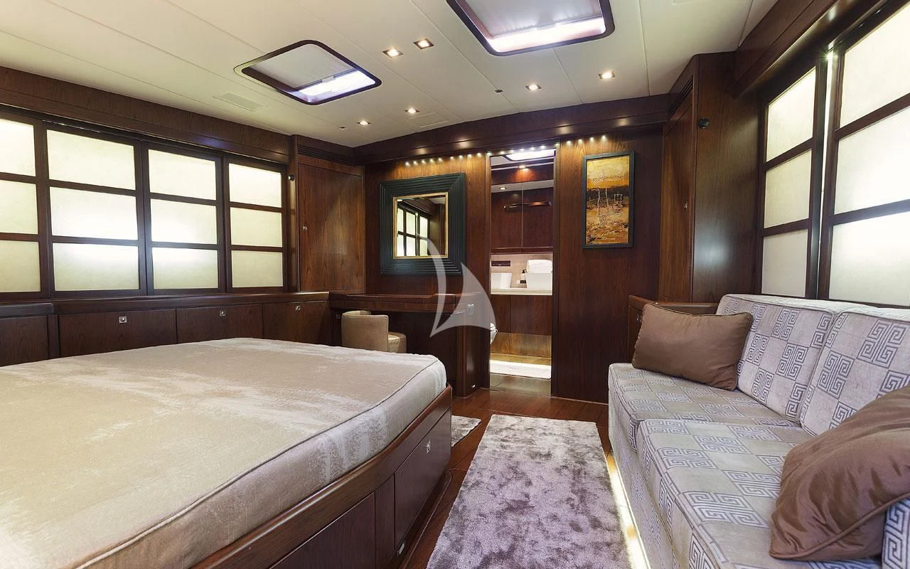 a room with a bed and a couch aboard FAR AND WIDE Yacht for Sale