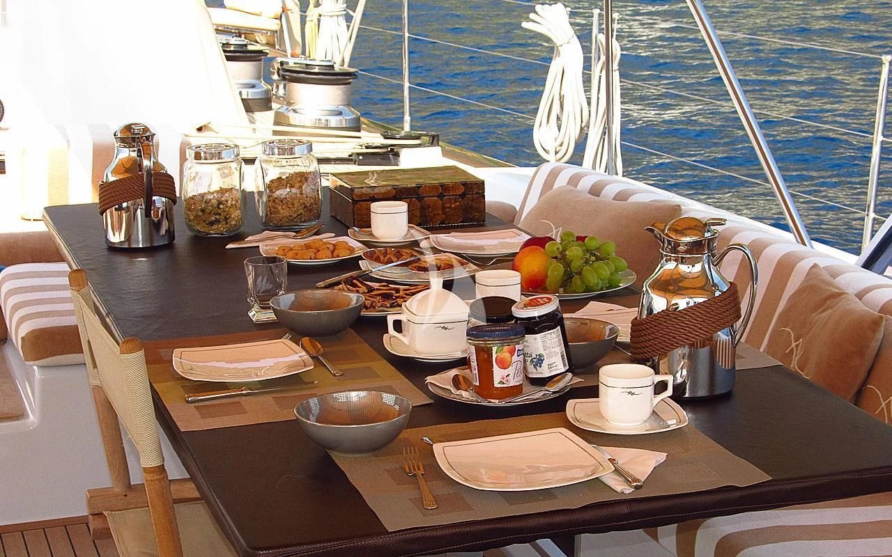 a table with food and drinks on it aboard FAR AND WIDE Yacht for Sale