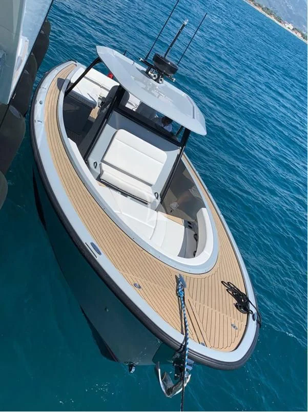 a small boat on a blue surface aboard VICKY Yacht for Charter