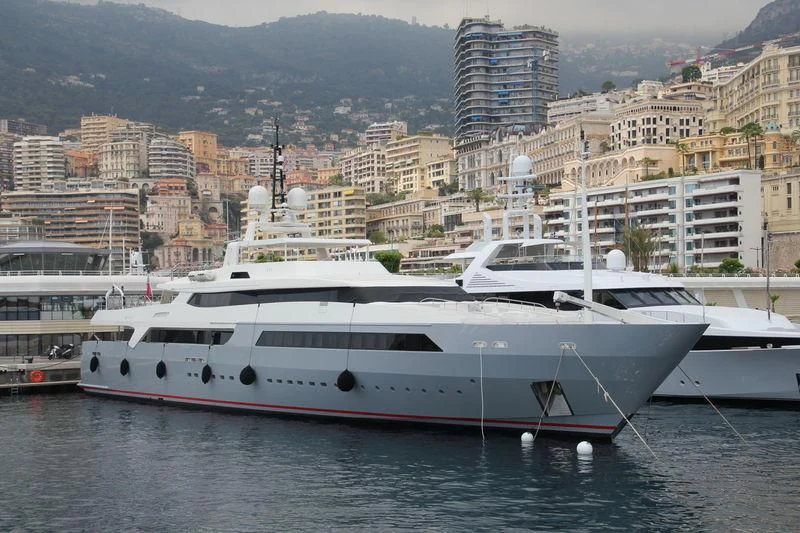 a couple of boats sit in a harbor aboard VICKY Yacht for Charter