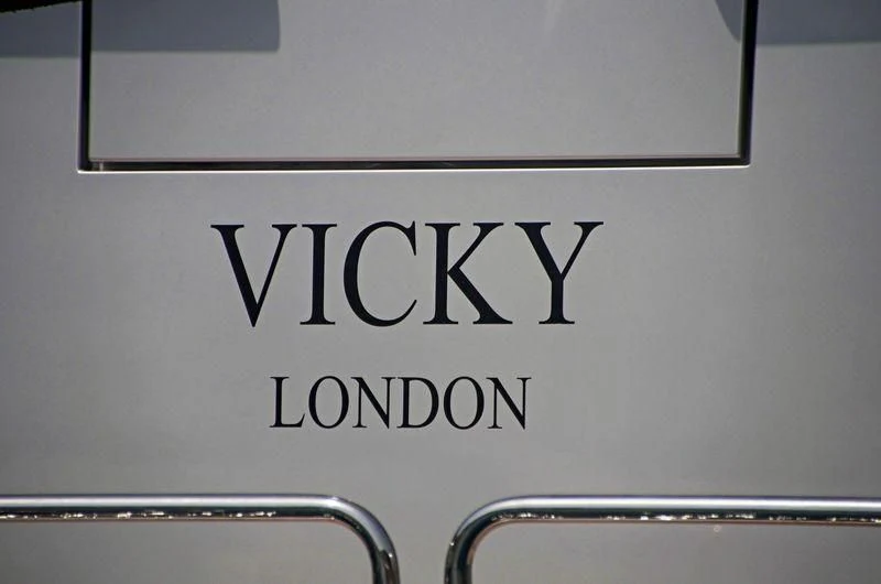 a white sign with black text aboard VICKY Yacht for Charter