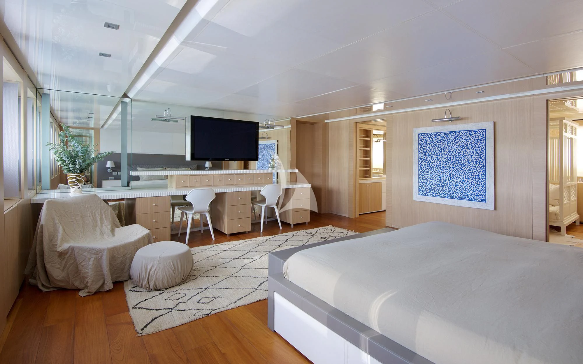 a large room with a bed and a tv aboard VICKY Yacht for Charter