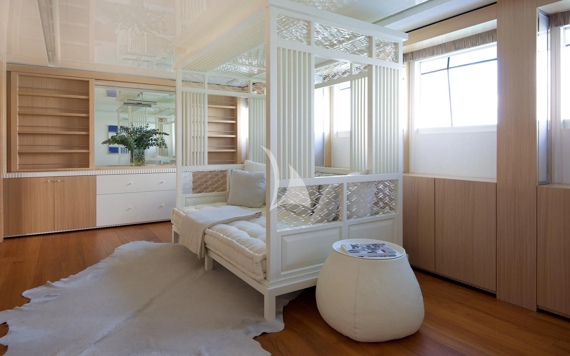 a room with a bed and a chair aboard VICKY Yacht for Charter