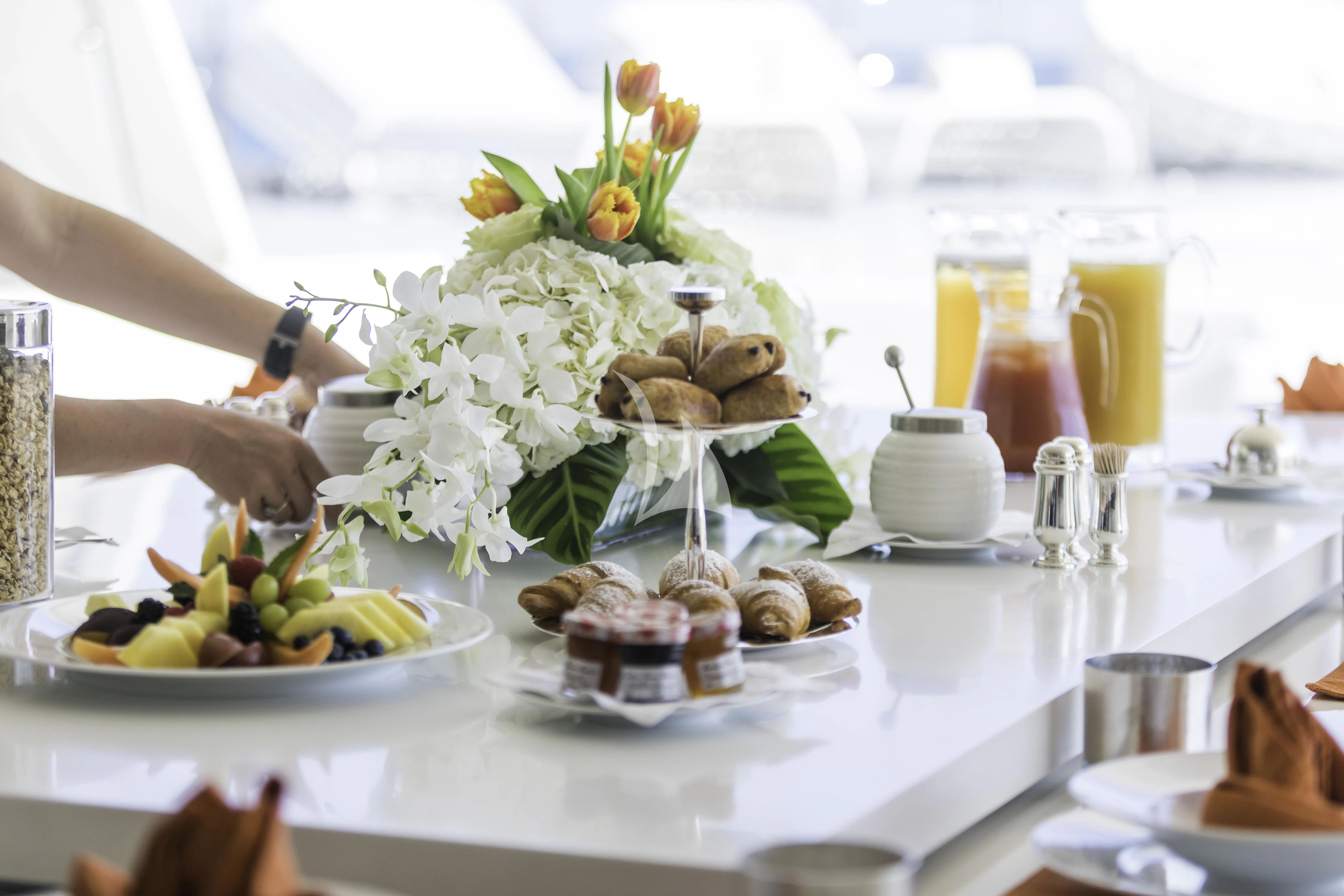 a table with food and drinks aboard VICKY Yacht for Charter