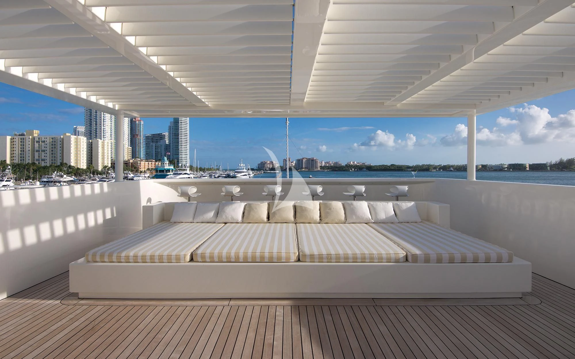 a large white room with a wood floor and a view of a city aboard VICKY Yacht for Charter