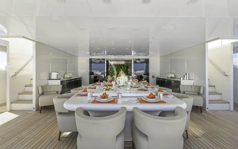 a large white dining table aboard VICKY Yacht for Charter