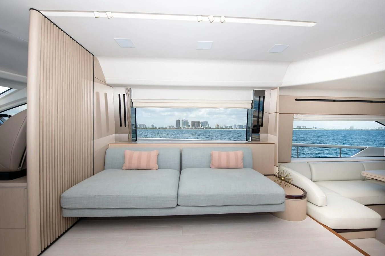 a living room with a large window aboard CRIMSON Yacht for Sale