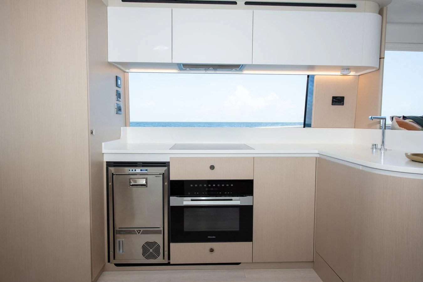 a kitchen with white cabinets aboard CRIMSON Yacht for Sale